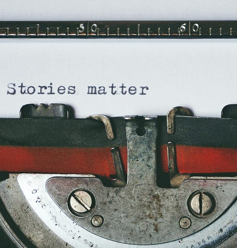 Close-up of a vintage typewriter with the text 'Stories matter' typed on paper, evoking nostalgia.